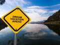 dream vacation ahead traffic sign on blue sky Royalty Free Stock Photo