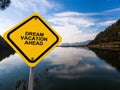 dream vacation ahead traffic sign on blue sky