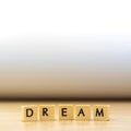 dream word written in cube on wooden floor on white background Royalty Free Stock Photo
