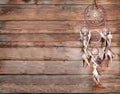 Dreamcatcher, american native amulet on wooden background. Shaman