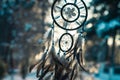 Dreamcatcher, spiritual protection amulet with feathers on sunset background.