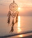 Dreamcatcher, on sunrise sea background, magical indian shaman amulet,