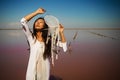 Dreamcatcher at sunset , asian girl boho chic with ethnic amulet at pink sea. symbol peace and harmony.