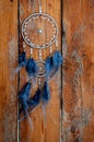 Dreamcatcher on wooden background. Indian shaman lucky amulet. Boho