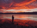 Dreamer, silhouette of woman standing along the lake at sunset, human strength, psychology concept Royalty Free Stock Photo