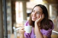 Dreamer woman drinking coffee and dreaming in a bar Royalty Free Stock Photo