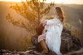 Dreamer woman meeting sunrise at the mountains