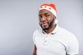 Dreamful guy standing in Santa Claus hat