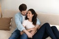 Dreamful family couple relaxing on sofa at living room chatting Royalty Free Stock Photo