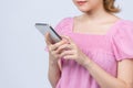 Dreamful young woman in pajamas sleep eye mask rest relaxing on mobile cell phone solated on white background