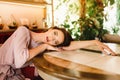 Dreamily young girl is laying on the table and looking at the camera. Dreming lifestyle. Natural beauty of a woman Royalty Free Stock Photo