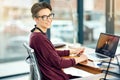 Dreaming it and achieving it. Portrait of a young businesswoman working on a laptop in a modern office.