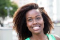 Dreaming african american woman in a green shirt outdoor Royalty Free Stock Photo