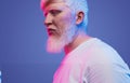 Dreaming albino man on multicolored neon background Royalty Free Stock Photo