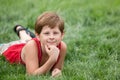 Dreaming boy on the green grass Royalty Free Stock Photo