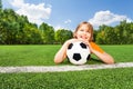 Dreaming boy holds football, looking and laying Royalty Free Stock Photo