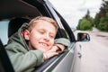 Dreaming boy look out from the car window Royalty Free Stock Photo