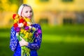 Dreaming Caucasian Blond Embracing Bunch of Colorful Tulips