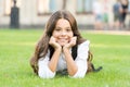 Dreaming of future. Happy girl relax on green grass. Small child with cute smile. Future generation. Future of education Royalty Free Stock Photo