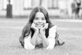 Dreaming of future. Happy girl relax on green grass. Small child with cute smile. Future generation. Future of education Royalty Free Stock Photo