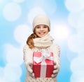 Dreaming girl in winter clothes with gift box Royalty Free Stock Photo