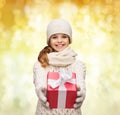 Dreaming girl in winter clothes with gift box Royalty Free Stock Photo