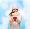 Dreaming girl in winter clothes with red heart Royalty Free Stock Photo