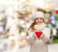 Dreaming girl in winter clothes with red heart Royalty Free Stock Photo