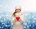 Dreaming girl in winter clothes with red heart Royalty Free Stock Photo