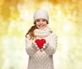 Dreaming girl in winter clothes with red heart Royalty Free Stock Photo