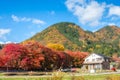 Dreaming house with maple tree corridor and rear mountain Royalty Free Stock Photo