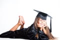 Dreaming little girl in graduation dress on isolat Royalty Free Stock Photo