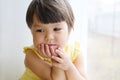 Dreaming little girl portrait leans on elbows on window longing for something. smiling child thinking about pleasing thought Royalty Free Stock Photo