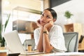 Dreaming of more exciting days. a young businesswoman day dreaming at her desk. Royalty Free Stock Photo