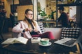 Dreaming pretty lady thinking of ideas sitting in cafe, creative profession. theme modern female blogger. young woman with pen in