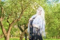 Dreaming Sensual Blond Woman Standing Outdoors in Spring Forest.