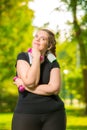 dreaming about slim body model plus size is engaged with dumbbells during a workout in a summer