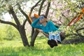 Dreaming woman in carnival sunglasses is relaxing in a hammock