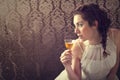 Dreaming woman drinks a glass of excellent Scotch whisky