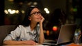 Dreaming woman sitting front laptop, tired of boring work, inattentive employee