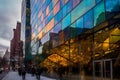 Dreamlike Cityscape Reflection on Glass Building Facade