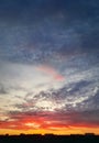 Dreamlike colorful sunset over the city horizon, vertical celestial background