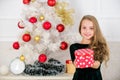 Dreams come true. Best for our kids. Kid girl near christmas tree hold gift box. Child celebrate christmas at home Royalty Free Stock Photo