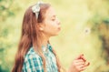 Dreams come true. Dandelion full symbolism. Summertime fun. Beliefs about dandelion. Girl making wish and blowing Royalty Free Stock Photo