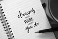 DREAMS DON`T WORK UNLESS YOU DO hand-lettered in notebook Royalty Free Stock Photo