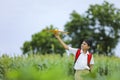 dreams of flight! indian child playing with toy airplane at green field