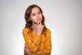 Dreams. girl with light hair holds finger to face Royalty Free Stock Photo