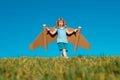 Dreams of travel. Child flying on jetpack with toy airplane on sky background. Happy child boy playing in cardboard Royalty Free Stock Photo