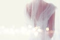 Dreamy abstract and blurry background of beautiful bride with wedding dress, from behind