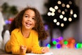 Dreamy african child writing wishlist for Christmas holidays Royalty Free Stock Photo